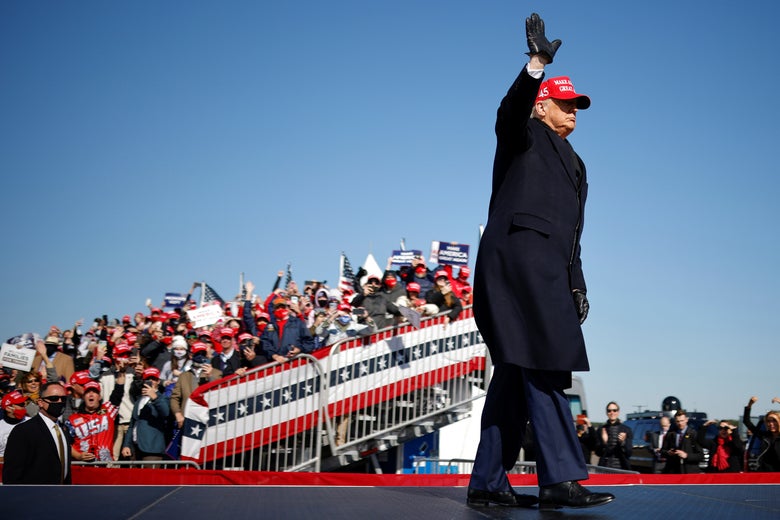 Trump waving with a crowd in the background