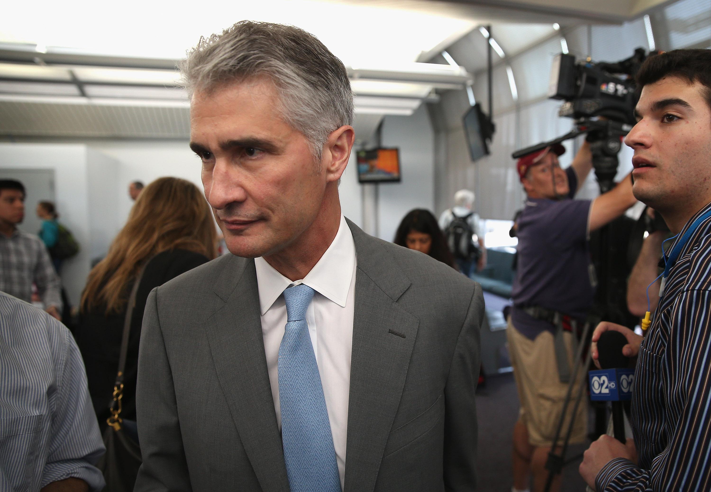 United Airlines CEO Jeff Smisek leaves the gate after stepping off a United Boeing 787 Dreamliner flight from Houston at O'Hare International Airport on May 20, 2013, in Chicago.