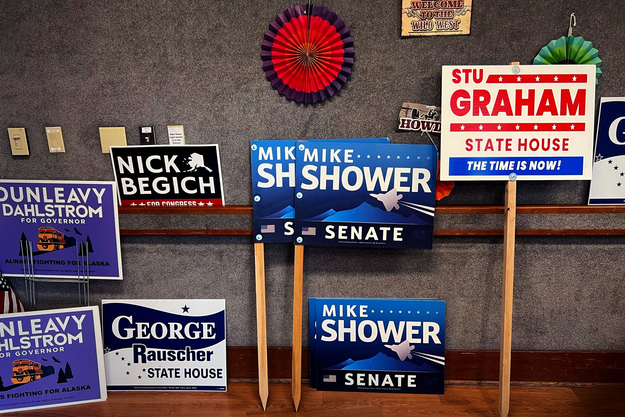 Political signs leaned up against the wall at the cook-off.