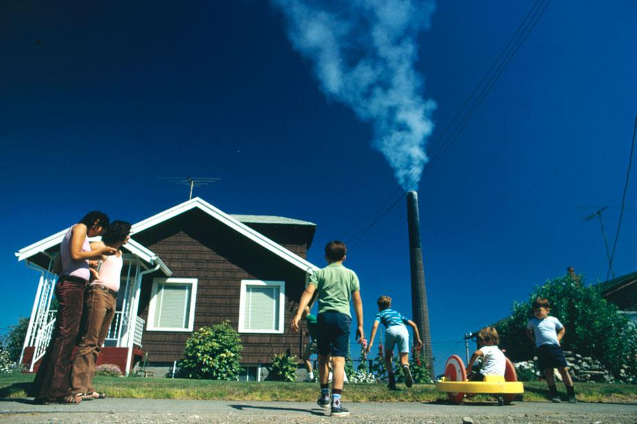 “Children play in yard of Ruston home, whileTacoma smelter stack showers area with arsenicand lead residue.”Gene Daniels, Ruston, Washington, August 1972