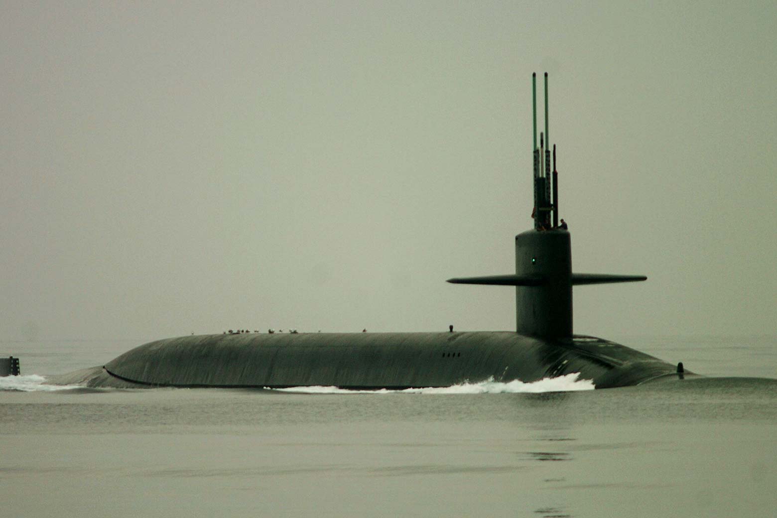 A submarine mostly submerged in water.