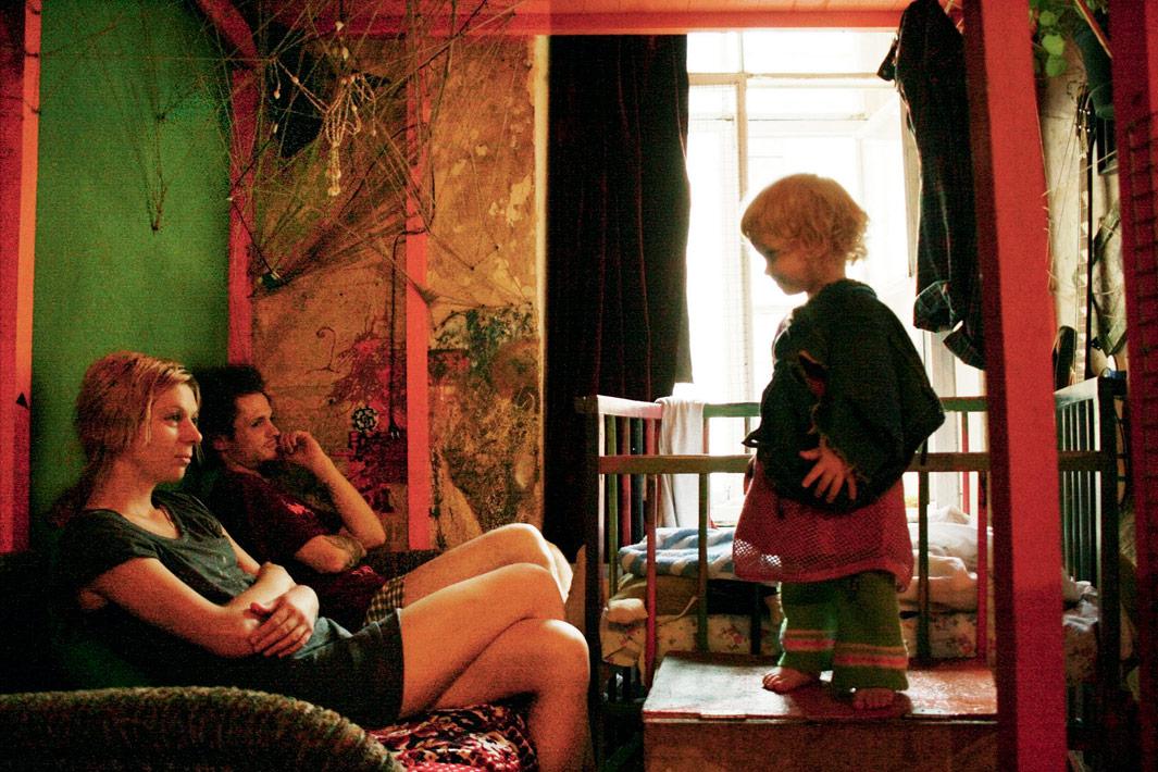Lila and Pasha are looking at their daughter. Lila and Pasha live together for five years. They have a daughter, Anfisa, 2 years old. They are punks and drug-users, their home is often noisy and full of occasional guests. Lilya has sexually transmitted desease and doesn't know her HIV diagnoses. Unthough all that, they love each other and their little daughter and try to take care of her properly.