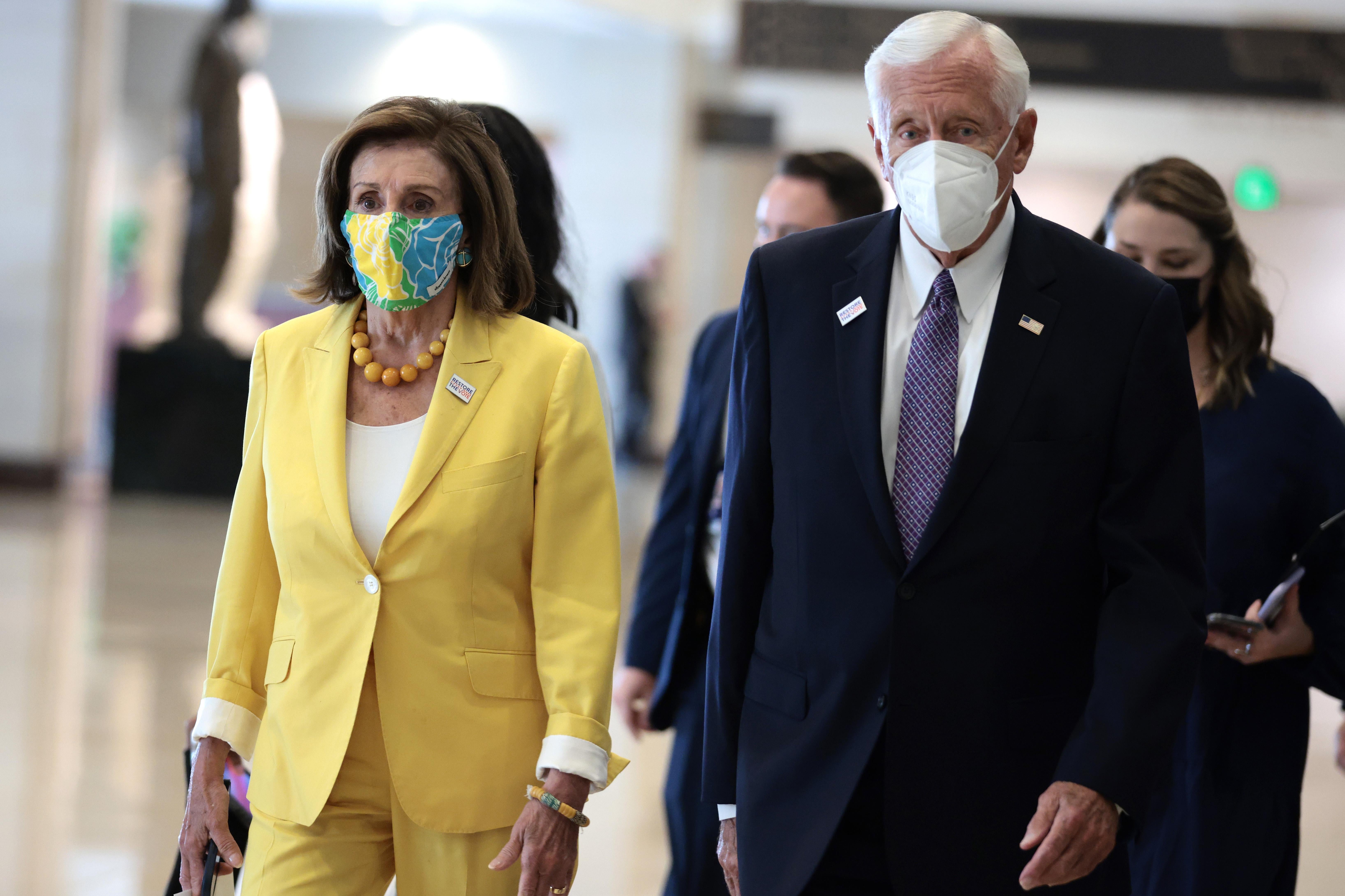 House Speaker Nancy Pelosi walks down a Capitol Hill hallway with House Majority Leader Steny Hoyer on August 24, 2021. 