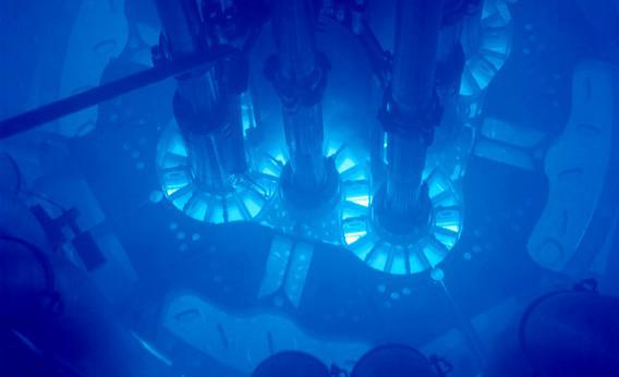 Samples from Idaho National Laboratory's Advanced Test Reactor (ATR) core will be sent to Argonne's ATLAS particle accelerator for analysis to learn the characteristics of the nuclear material. Powered up, the fuel plates can be seen glowing bright blue. The core is submerged in water for cooling.