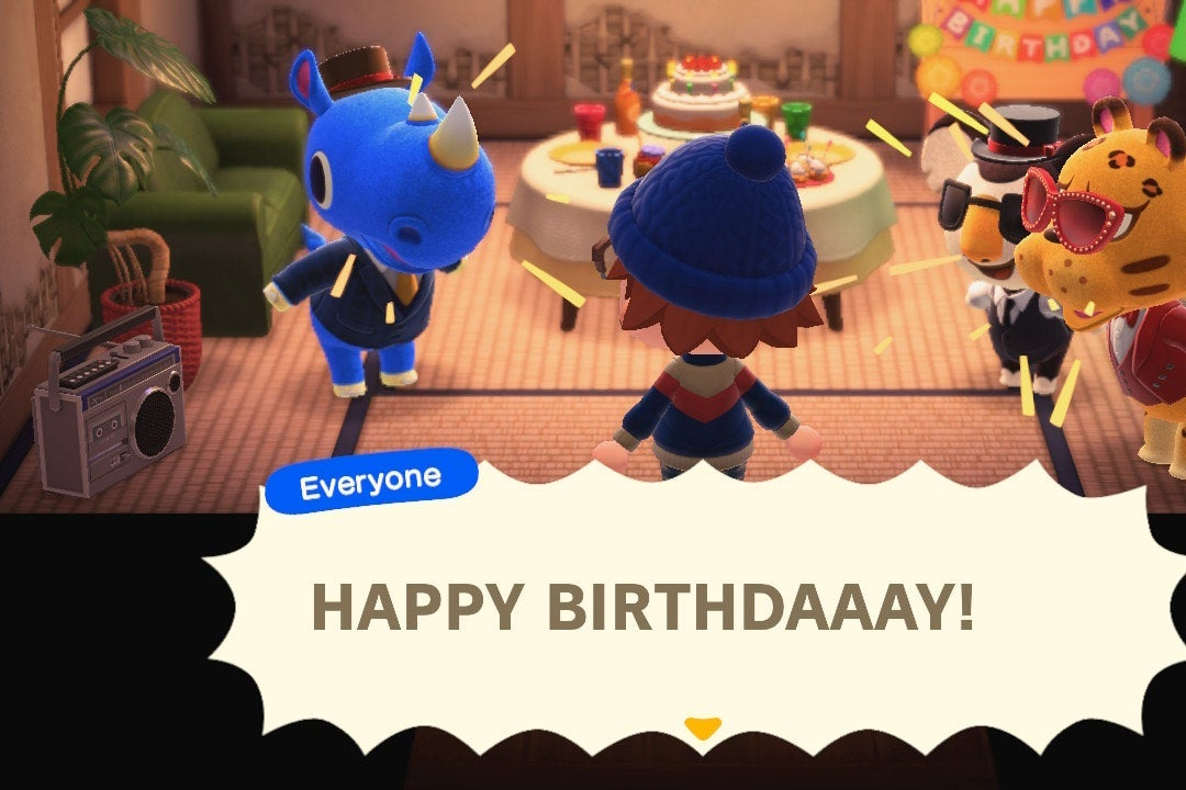 Three animal characters shout HAPPY BIRTHDAY at a human character with his back to the screen in a tatami-covered room.