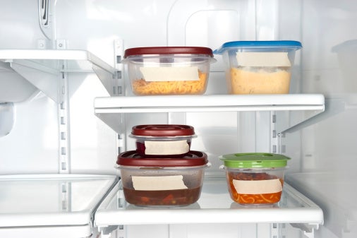 Picture of the inside of an office fridge, Tupperware with labels.