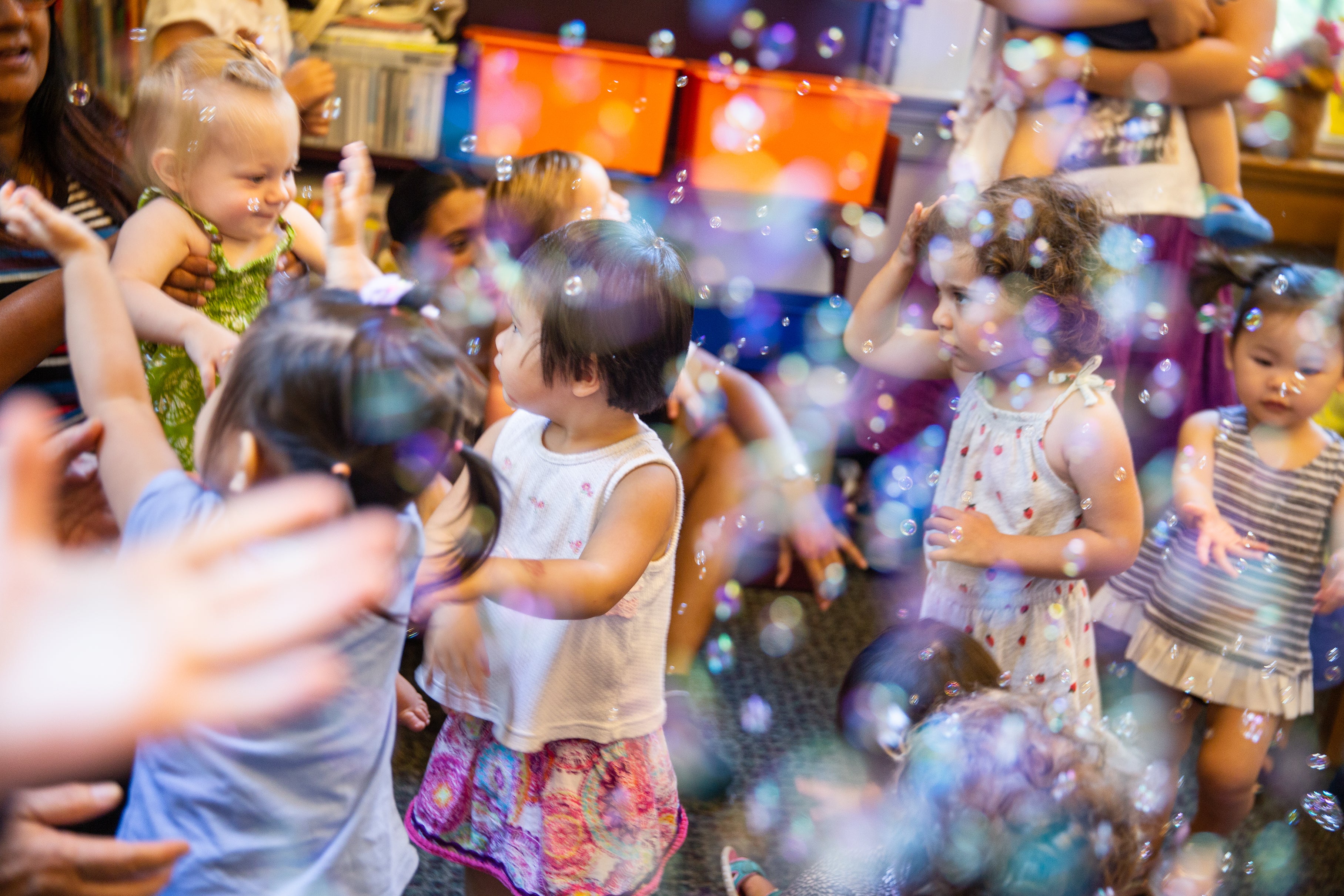 Children play amid bubbles.