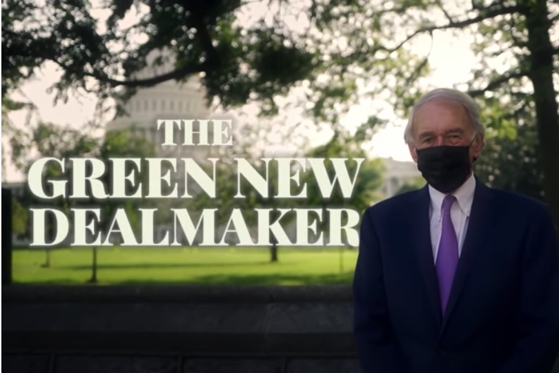 Ed Markey, wearing a mask, standing in front of the Capitol with the text "The Green New Dealmaker."