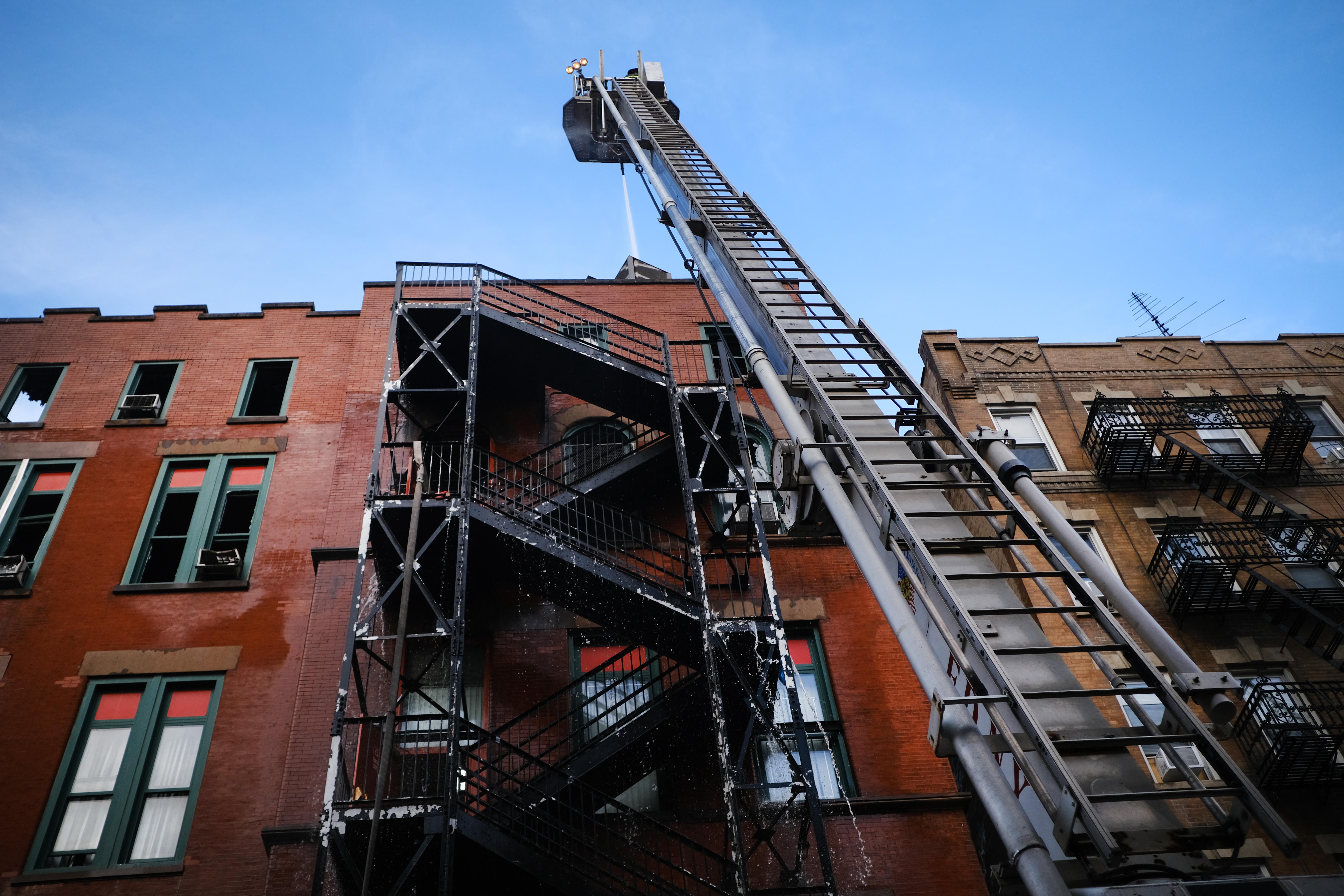 The building, as seen from below. A fire truck's ladder has been extended to an upper floor.