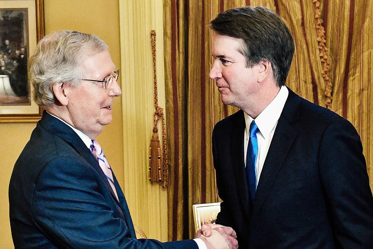 Sen. Mitch McConnell shakes hands with Judge Brett Kavanaugh in McConnell's D.C. office on July 10.