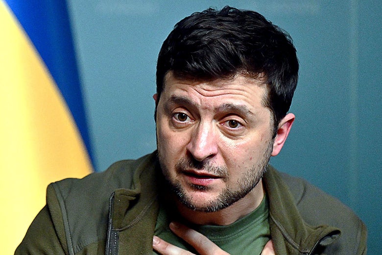 Ukrainian President Volodymyr Zelensky speaking, with hand on his chest, in casual clothing.