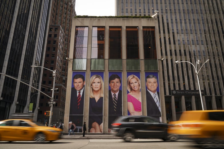 Traffic on Sixth Avenue passes by advertisements featuring Fox News personalities, including Bret Baier, Martha MacCallum, Tucker Carlson, Laura Ingraham, and Sean Hannity, adorn the front of the News Corporation building, March 13, 2019 in New York City. On Wednesday the network's sales executives are hosting an event for advertisers to promote Fox News. Fox News personalities Tucker Carlson and Jeanine Pirro have come under criticism in recent weeks for controversial comments and multiple advertisers have pulled away from their shows. (Photo by Drew Angerer/Getty Images)