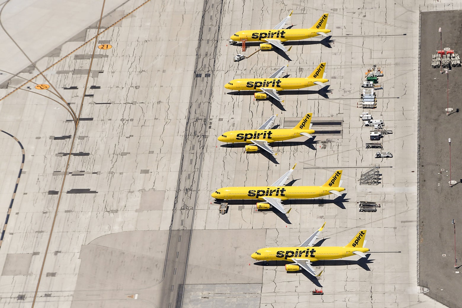 Aerial view of five Spirit planes waiting on the tarmac.