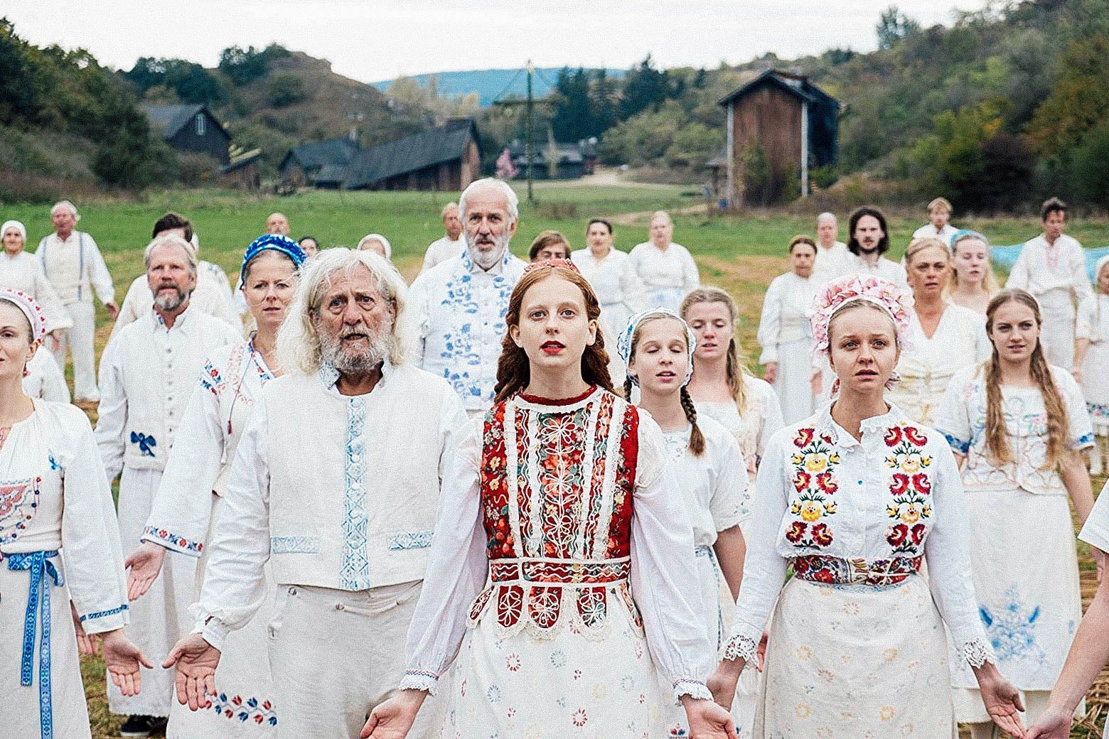 Still from Midsommar featuring some very dazed-looking members of the Harga