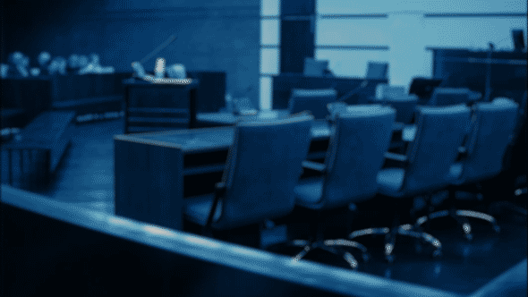 A courtroom blurring in and out of focus.