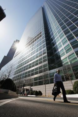 A man walks past Goldman Sachs headquarters.
