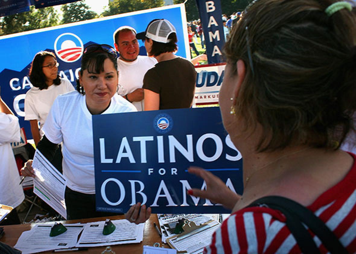 Democratic Party workers hand out signs at a celebration marking Mexican Independence Day September 14, 2008 in Denver, Colorado. 