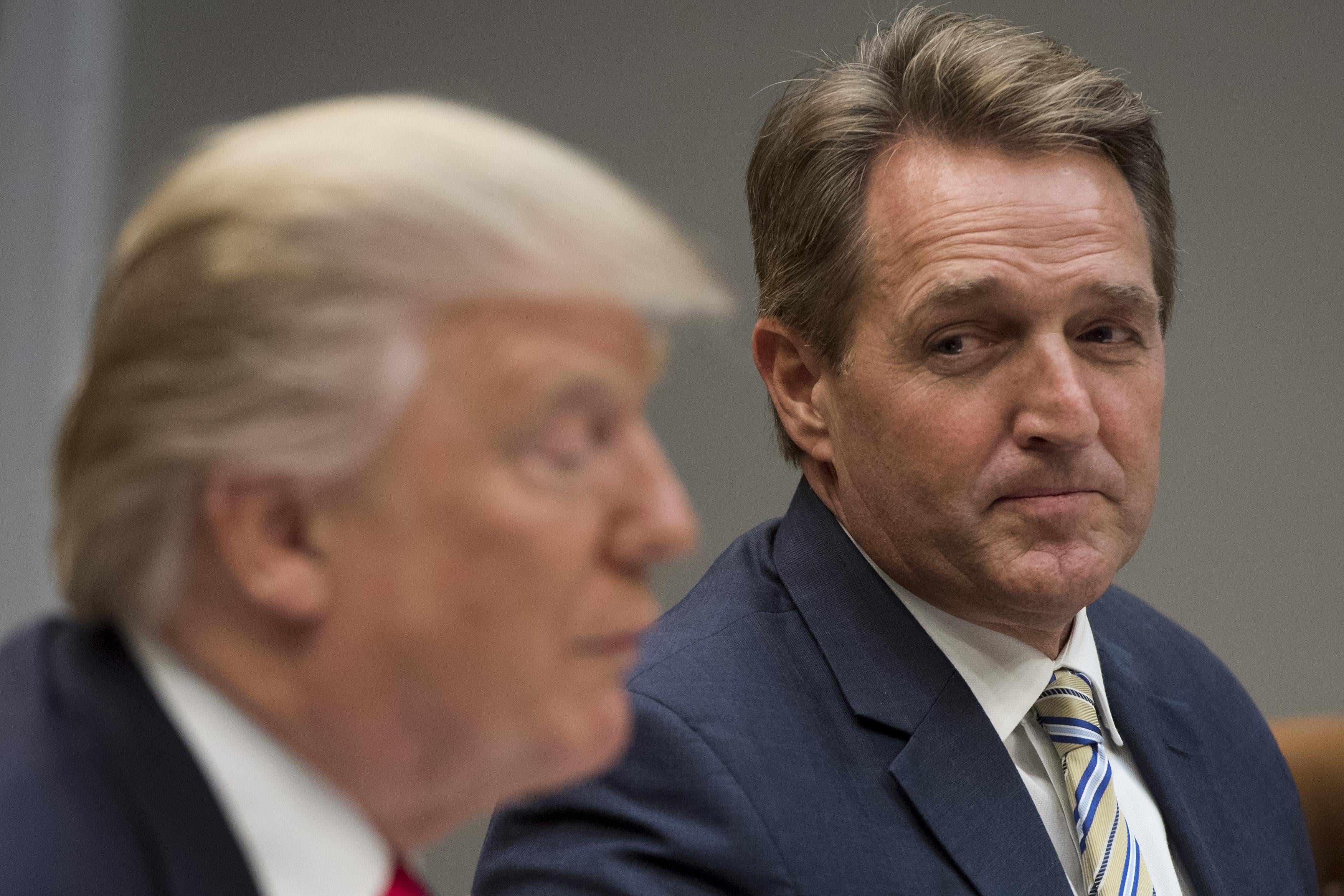 President Donald Trump speaks during a lunch meeting with Republican members of the Senate, including US Senator Jeff Flake (R), Republican of Arizona, in the Roosevelt Room of the White House in Washington, DC, December 5, 2017. 