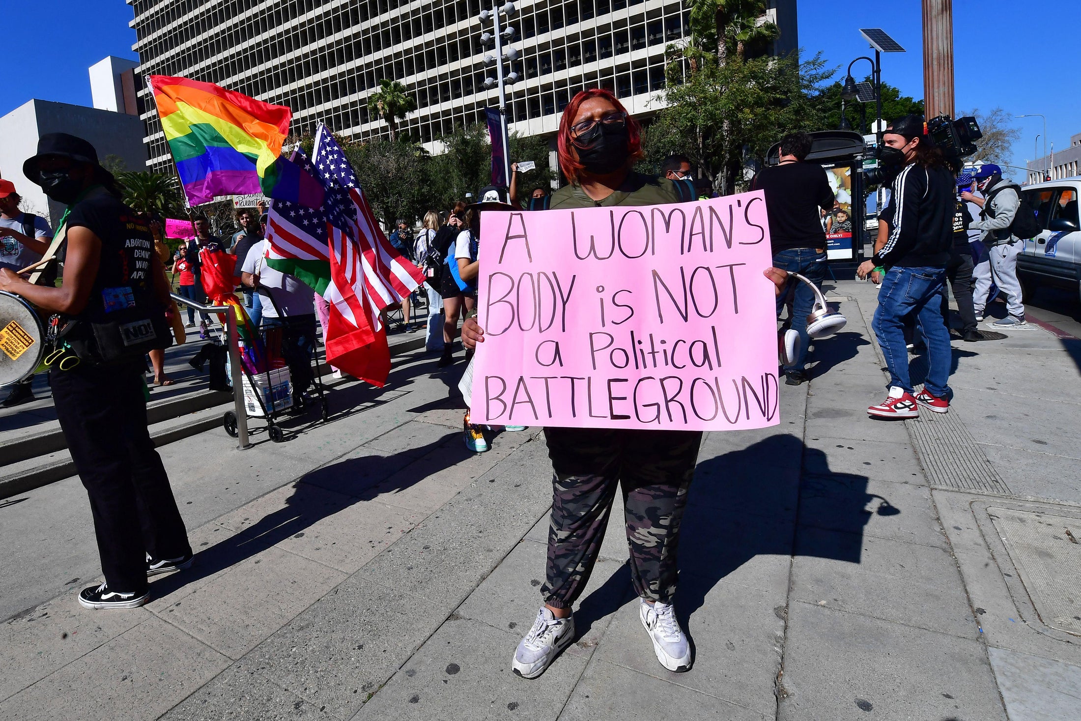 Activists hold signs as they gather on International Women's Day to oppose the growing assault on abortion rights ahead of a Supreme Court decision in Dobbs v. Jackson Women's Health Organization.