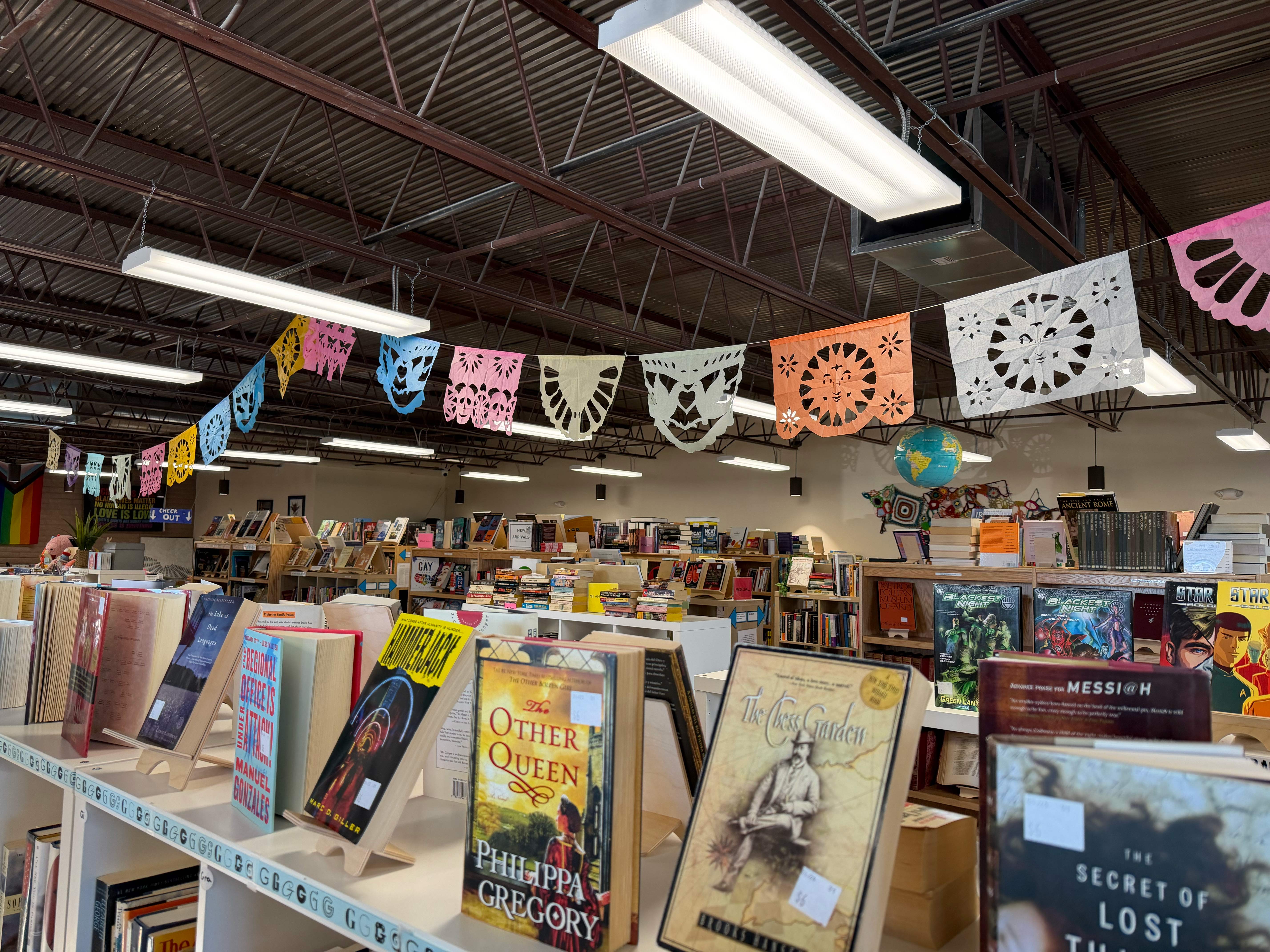 A nice, regular indie bookstore with shelves of books and colorful art. 