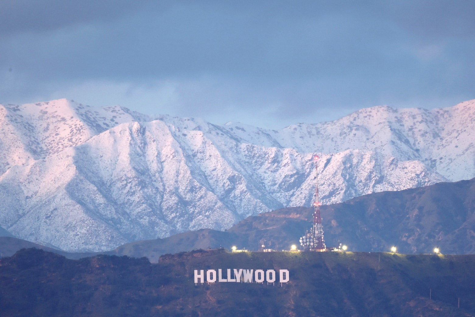 Snow on the mountains behind the Hollywood sign in L.A.
