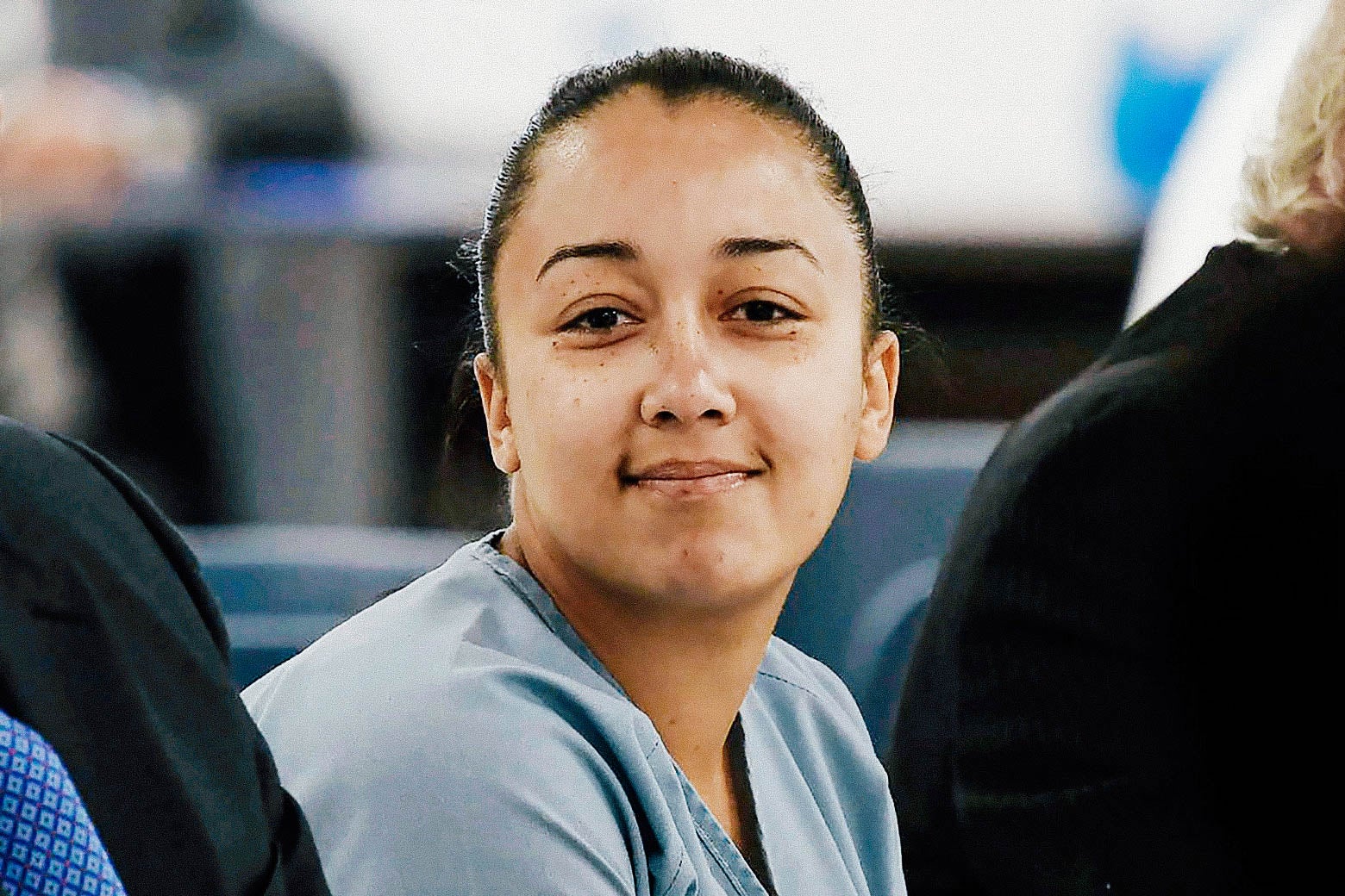 Cyntoia Brown, dressed in prison clothes, smiles toward the camera.