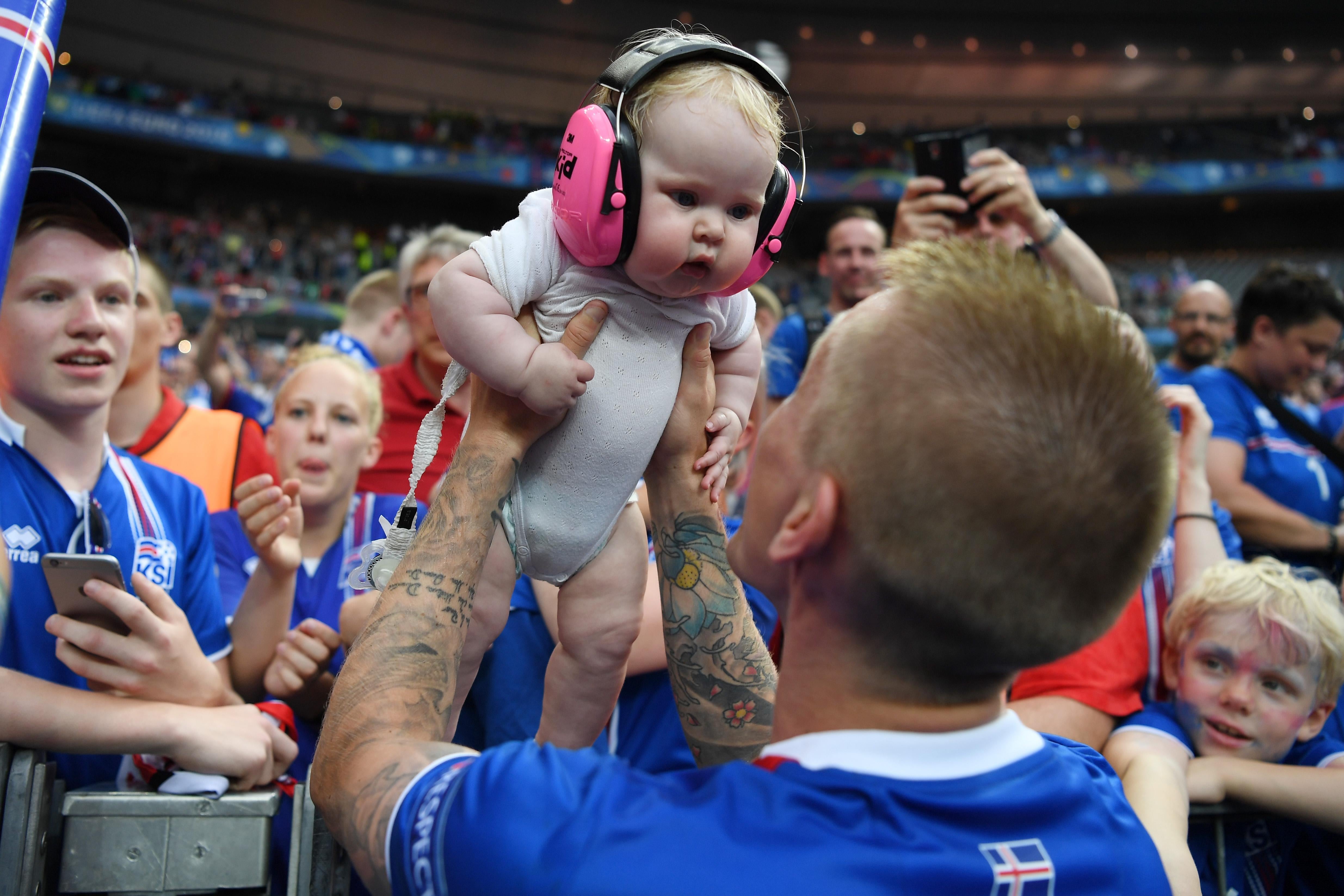 PARIS, FRANCE - JUNE 22:  Ari Skulason of Iceland celebrates his team's 2-1 win with his child after the UEFA EURO 2016 Group F match between Iceland and Austria at Stade de France on June 22, 2016 in Paris, France.  (Photo by Shaun Botterill/Getty Images)