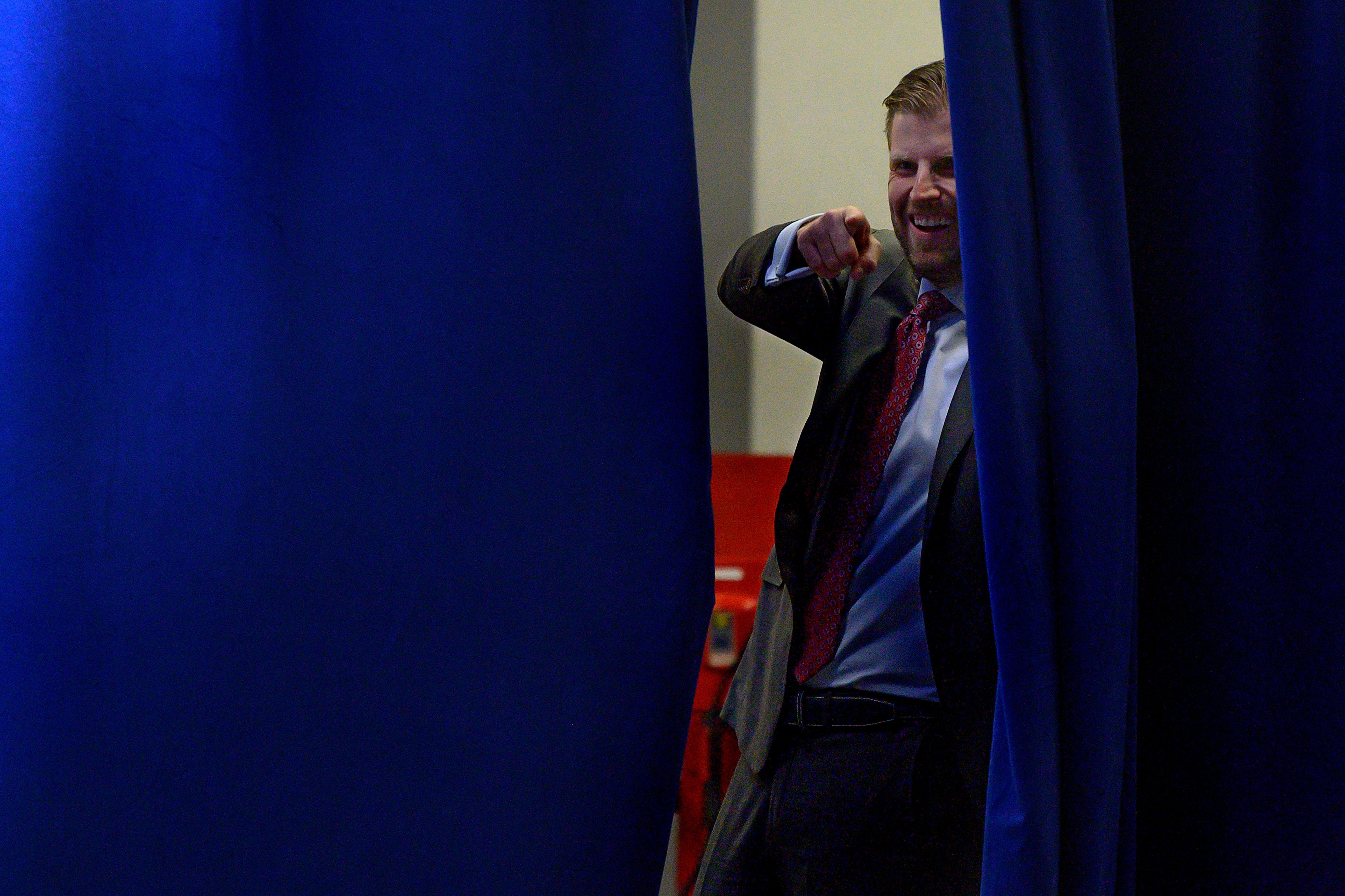 Eric Trump points from backstage prior to speaking during a press conference in Des Moines, IA, on February 3, 2020.