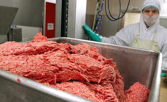 An employee works on June 2011, on the frozen ground beef production line.