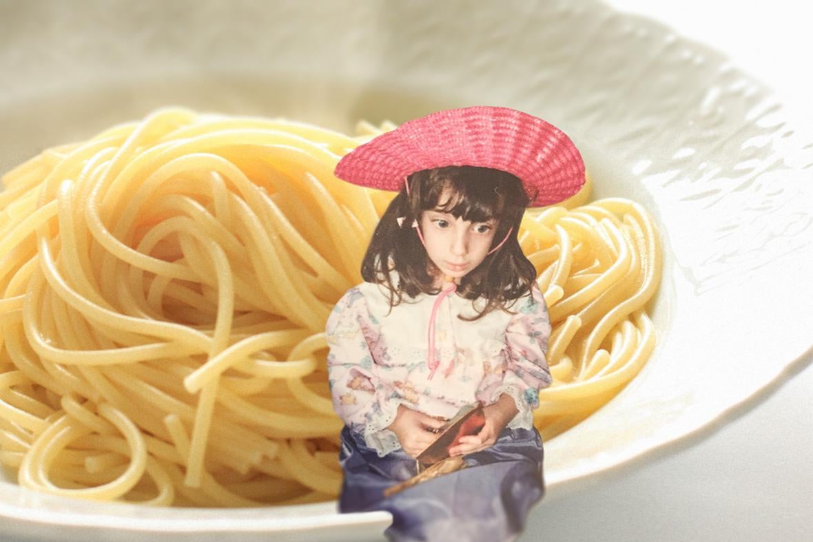 a girl sitting on a bowl of noodles