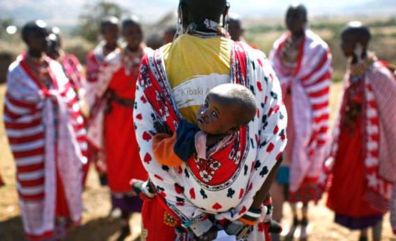 A Maasai woman carries her baby as she sings traditional songs during Emayian o nkituaak (blessing of women), a rare fertility ceremony in Kisokon village, southwest Nairobi September 28, 2008.
