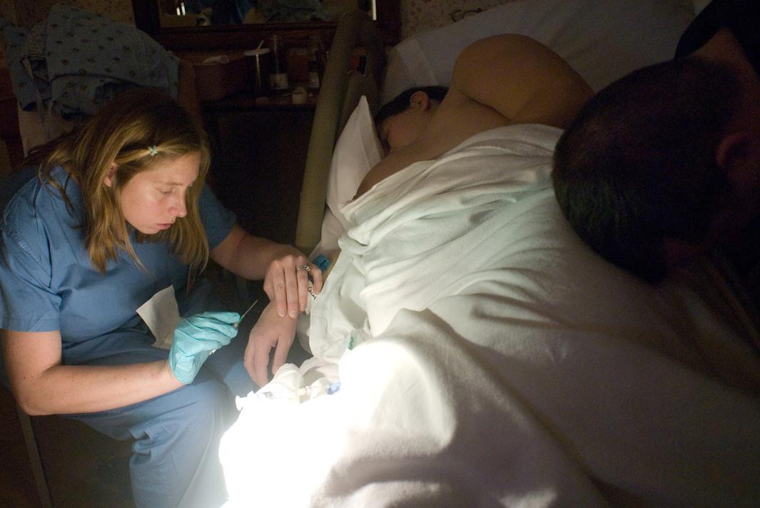 A nurse inserts Megan Tudryn's IV in preparation for an epidural at the Baystate Franklin Medical Center in Greenfield, MA. The staff encourages women to make their own decisions about pain management during labor.With few exceptions, midwifery forms the basis of the hospital's obstetric care, while doctors provide backup and a tertiary care hospital an hour away consults. 