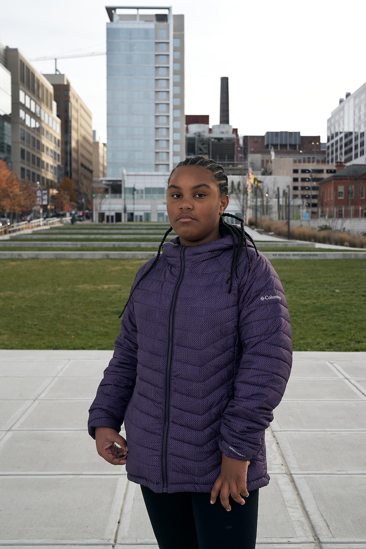 Kennedi, wearing a purple jacket standing outdoors, fifth grade.