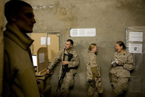 Lance Corporal Kristi Baker, 21, (L) shares a laugh with Hospital Corpsman Shannon Crowley, 22, US Marine with the FET (Female Engagement Team) 1st Battalion 8th Marines, Regimental Combat team II  while they stand in line to use the internet at their forward operating base on November 12, 2010 in Musa Qala, Afghanistan. 