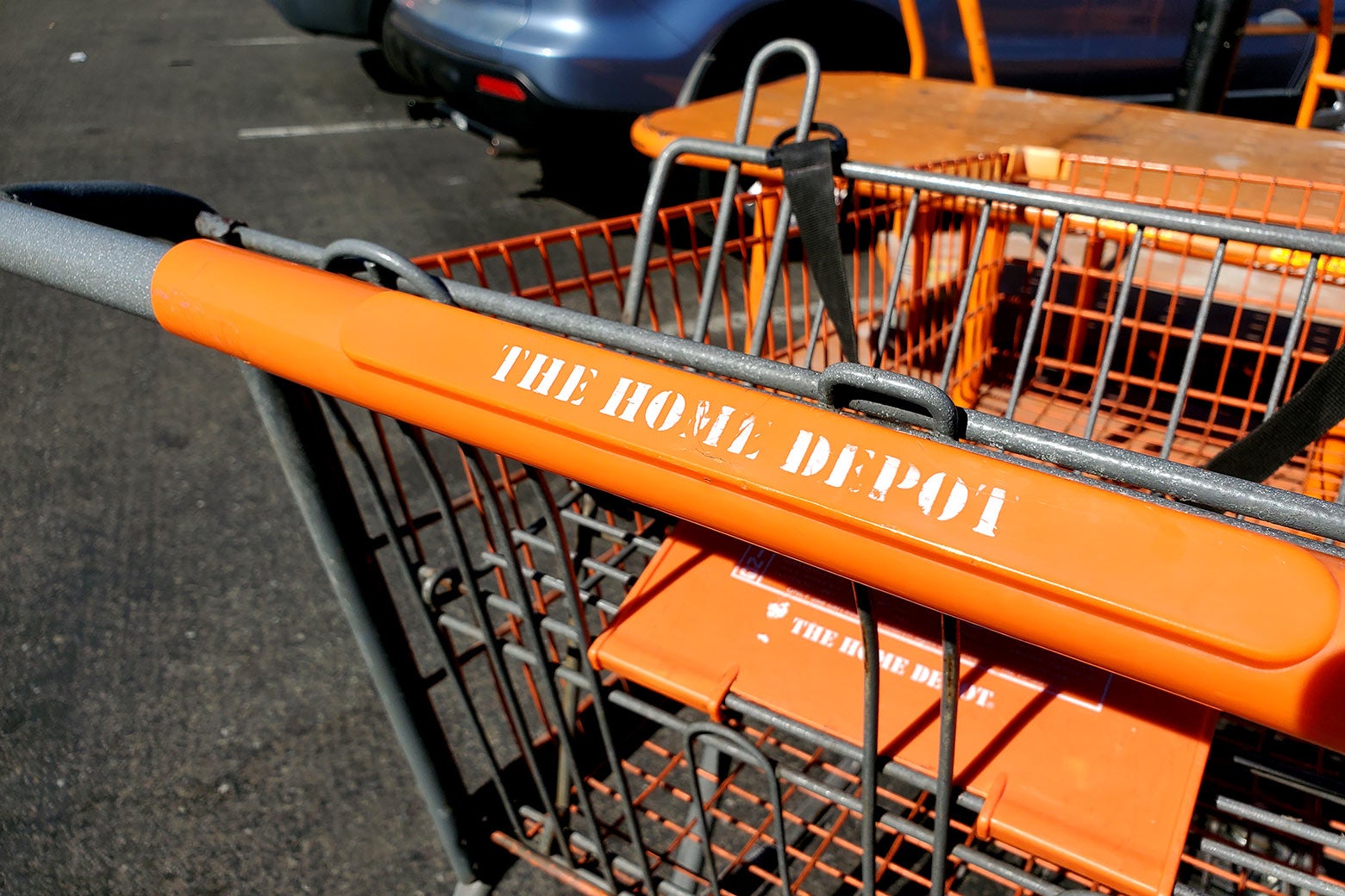 A closeup of an orange Home Depot shopping cart