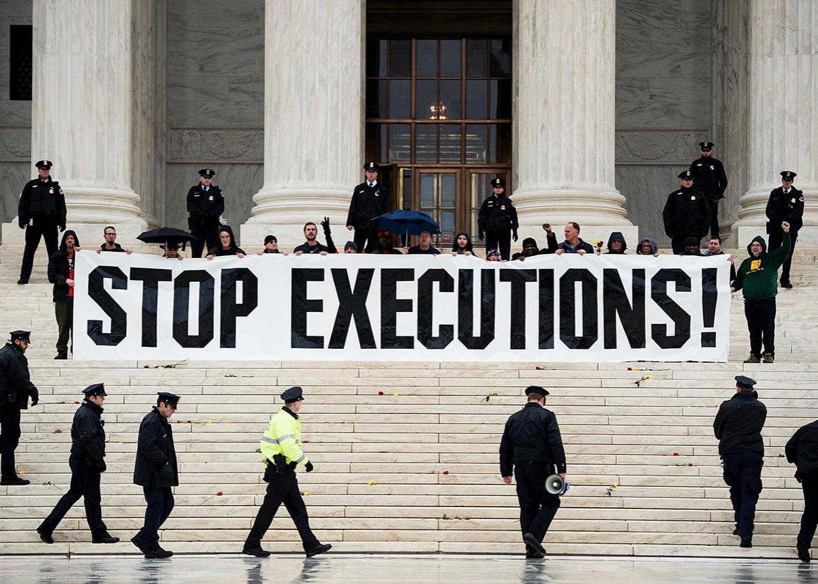 Police officers gather to remove activists during an anti death penalty protest in front of the US Supreme Court January 17, 2017 in Washington, DC. 