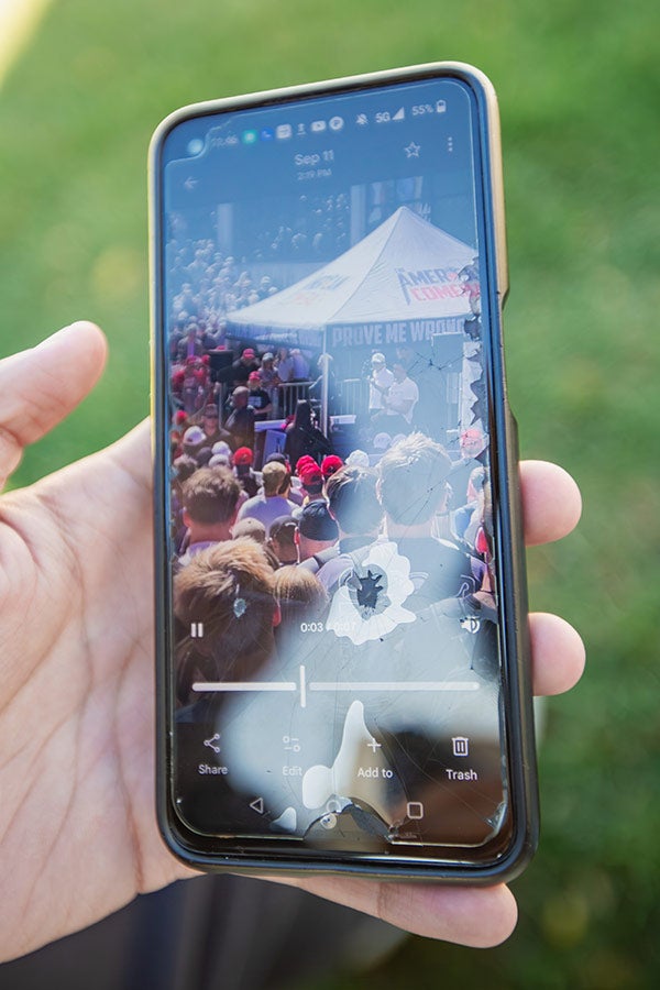 A shattered phone is showing the video of the shooting.