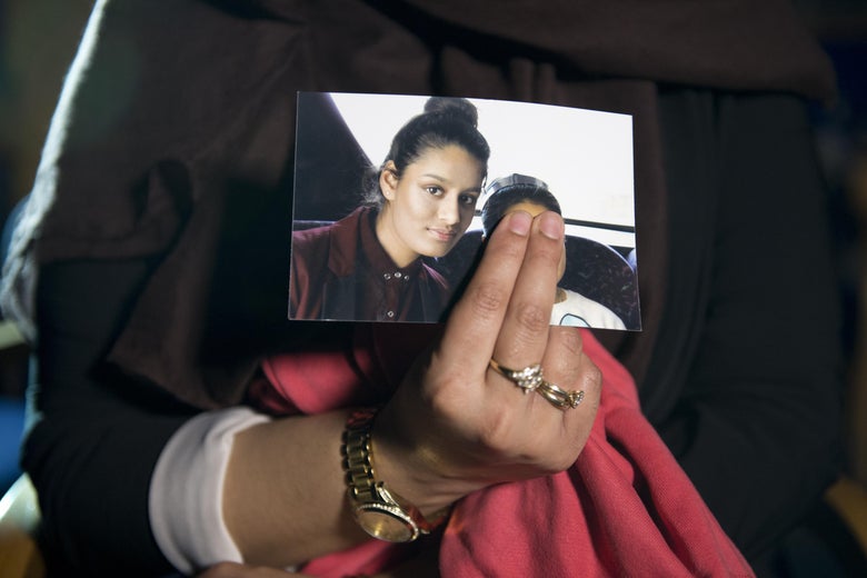 Renu Begum, eldest sister of Shamima Begum, 15, holds her sister's photo as she is interviewed by the media at New Scotland Yard on February 22, 2015 in London, England. 