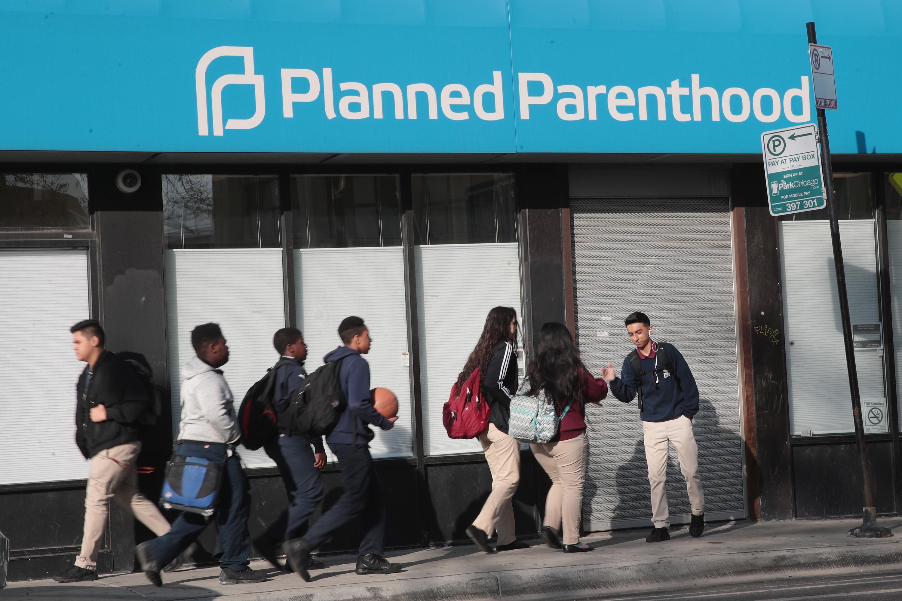 CHICAGO, IL - MAY 18:  Pedestrians walk past a Planned Parenthood clinic on May 18, 2018 in Chicago, Illinois. The Trump administration is expected to announce a plan for massive funding cuts to Planned Parenthood and other taxpayer-backed abortion providers by reinstating a Reagan-era rule that prohibits federal funding from going to clinics that discuss abortion with women or that share space with abortion providers.  (Photo by Scott Olson/Getty Images)