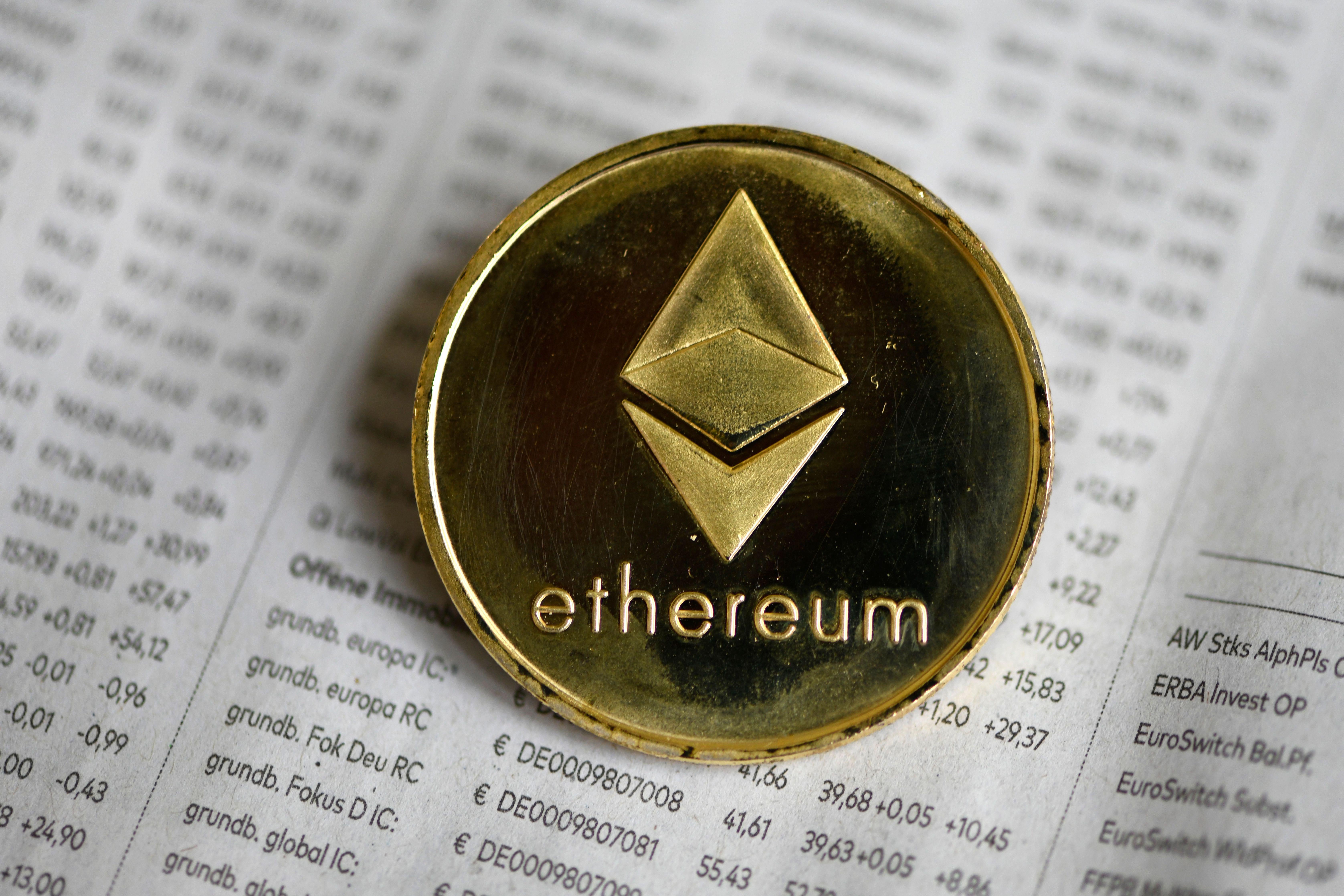The photo shows a physical imitation of a Ethereum cryptocurrency token.