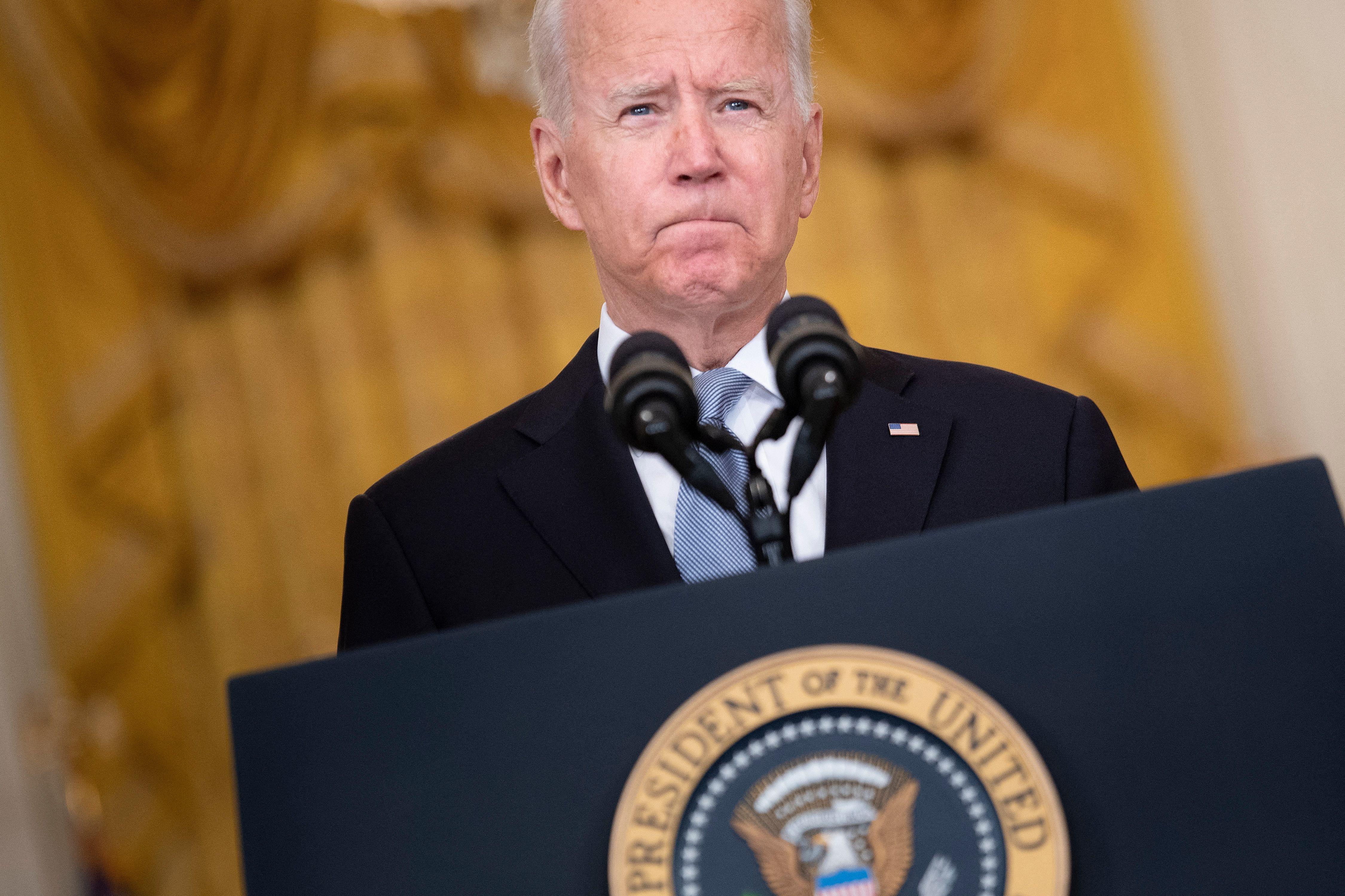 Joe Biden speaking at a presidential lectern