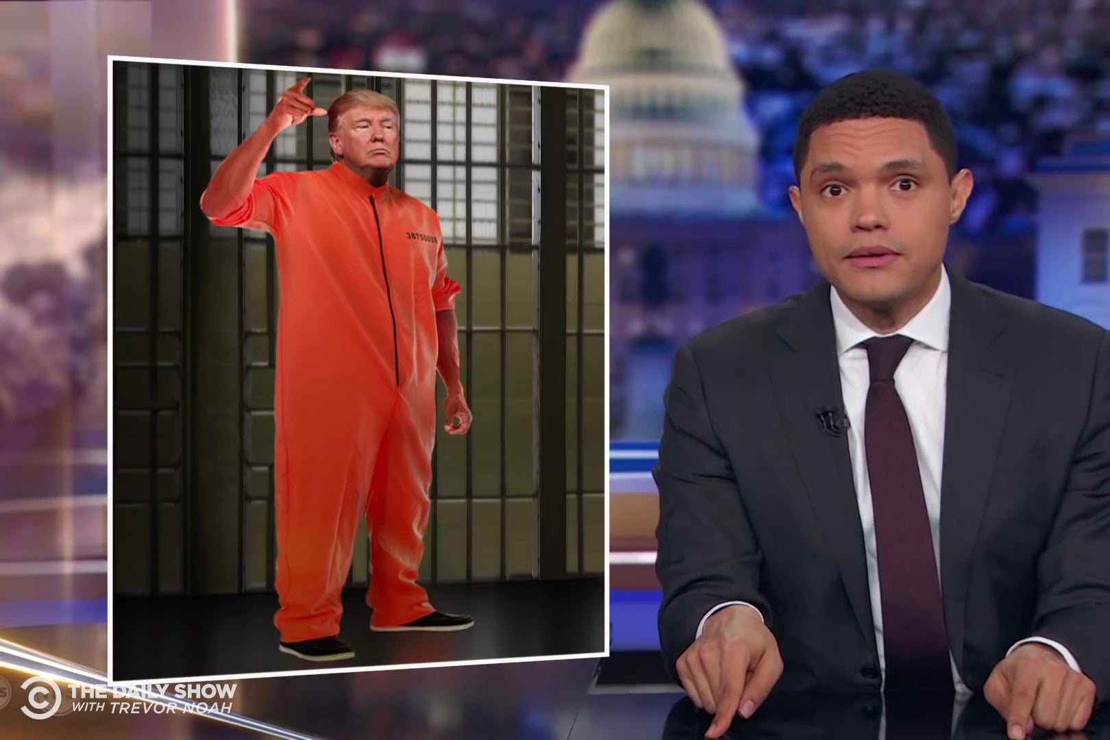 Trevor Noah in front of a Photoshopped image of Trump in a prison jumpsuit.