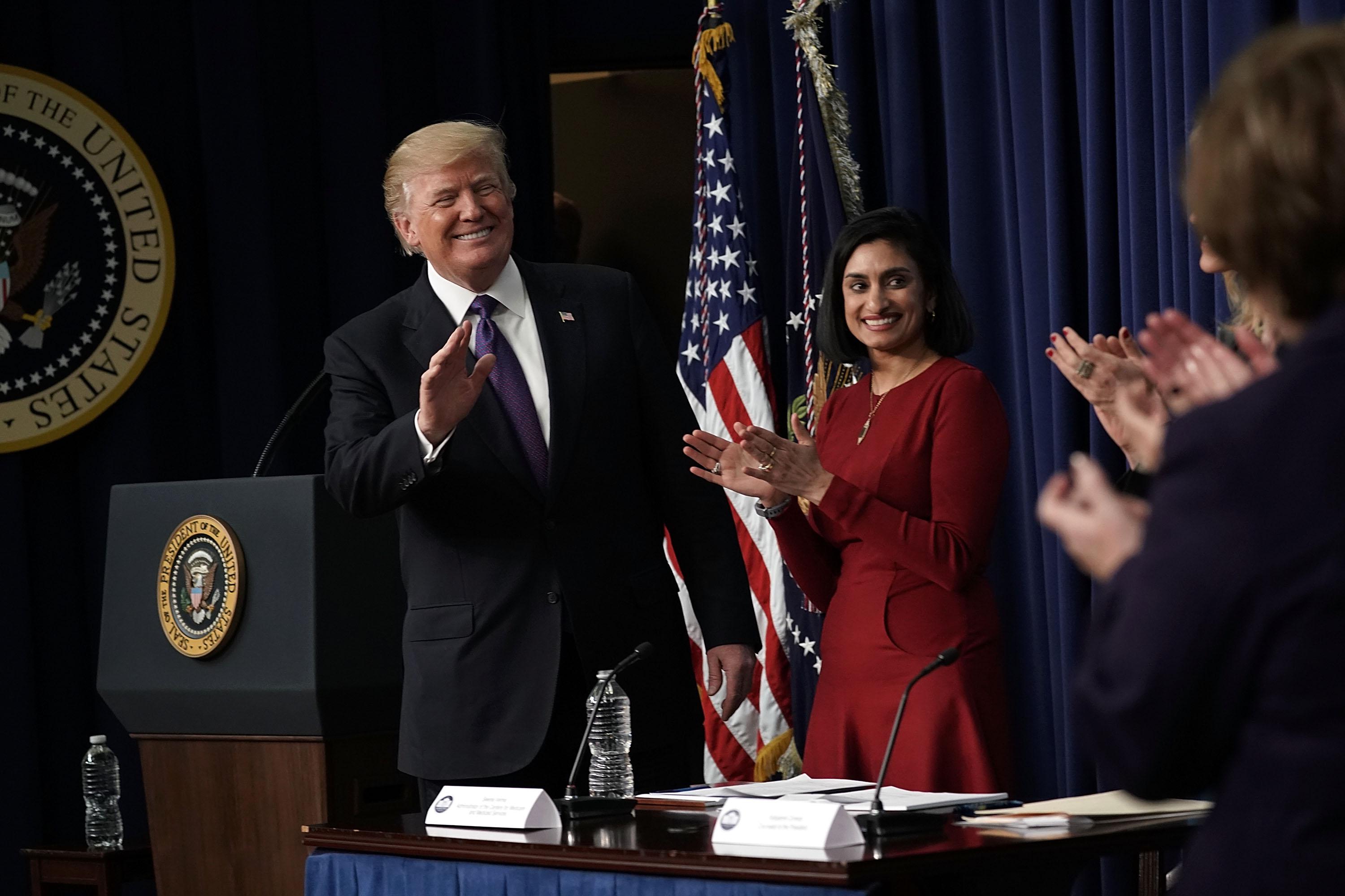 WASHINGTON, DC - JANUARY 16:  U.S. President Donald Trump (L) acknowledges the audience as Administrator of the Centers for Medicare and Medicaid Services Seema Verma (2nd L) looks on as he stops by a Conversations with the Women of America panel at the South Court Auditorium of Eisenhower Executive Office Building January 18, 2018 in Washington, DC. The three-part panel features ÒAmerican women from various backgrounds and experiences who will speak with high-level women within the Trump Administration, about what has been accomplished to date to advance women at home, and in the workplace.Ó  (Photo by Alex Wong/Getty Images)