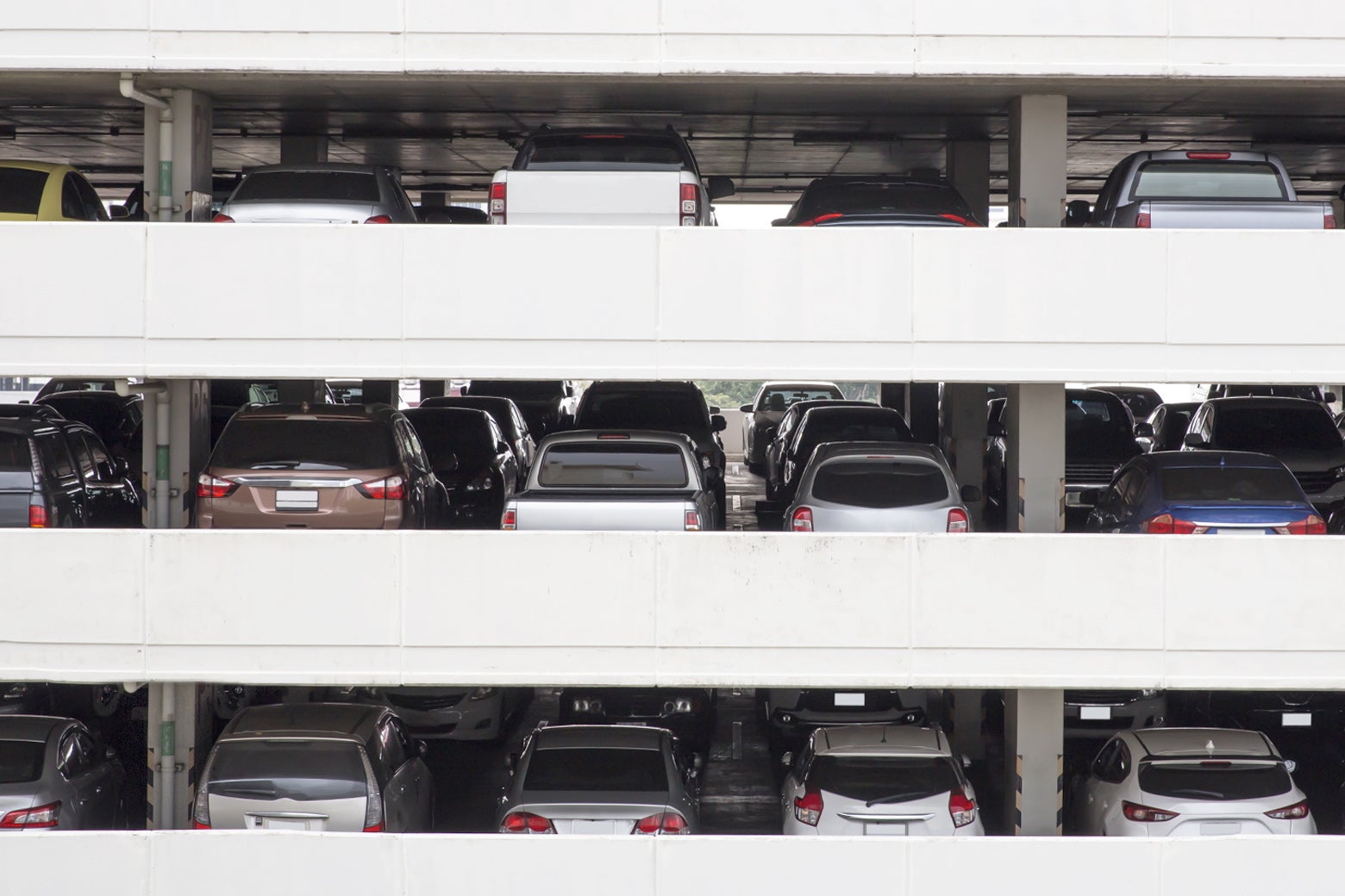 Three layers of a packed public parking garage.