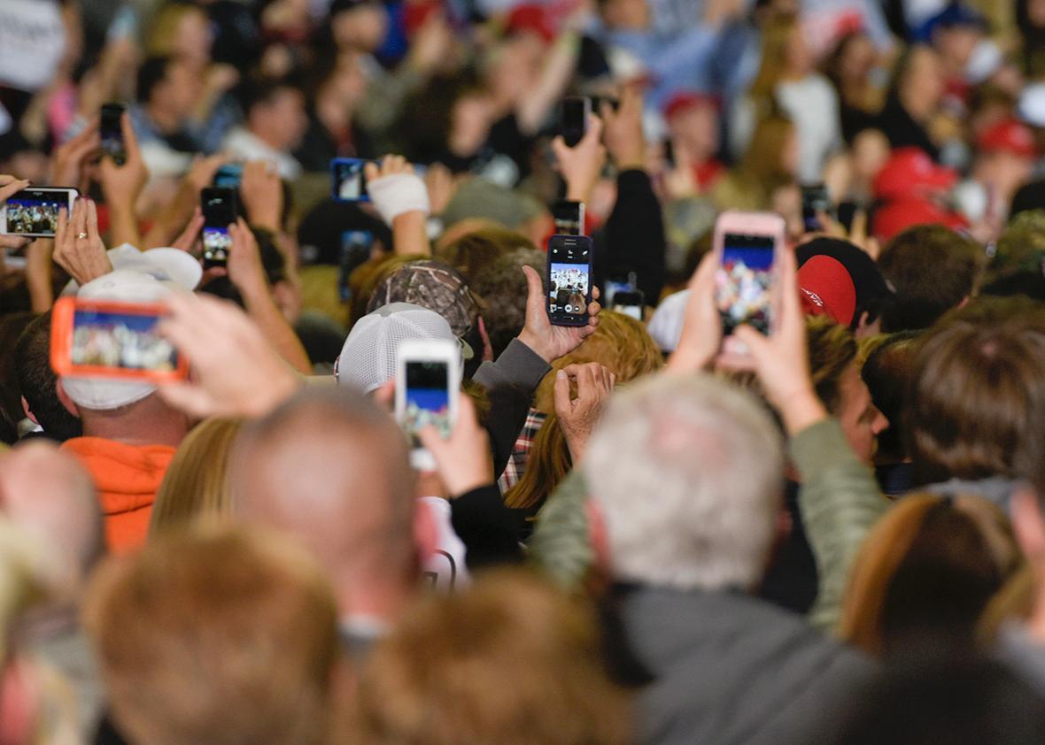 Supporters of Republican presidential nominee Donald Trump film him on their phones as he speaks during a rally at the Spire Institute in Geneva, Ohio on October 28, 2016.
