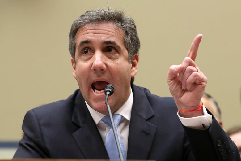 Michael Cohen points while testifying.