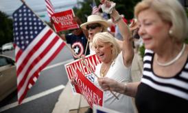 About 25 Republicans wave flags and signs in support of  Mitt Romney and Paul Ryan in Potomac, Md., earlier this week