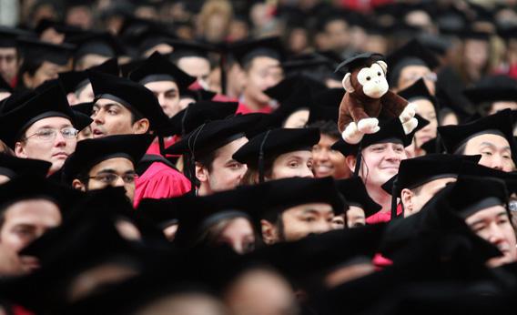 A graduating student wears a stuffed monkey on his head during Harvard University's commencement ceremonies in 2008, in Cambridge, Massachusetts. 