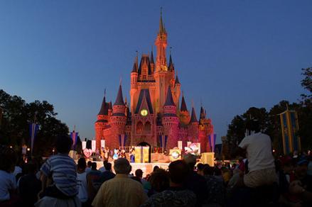 People watch a show on stage in front of Cinderella's castle at Walt Disney World's Magic Kingdom November 11, 2001 in Orlando, Florida.