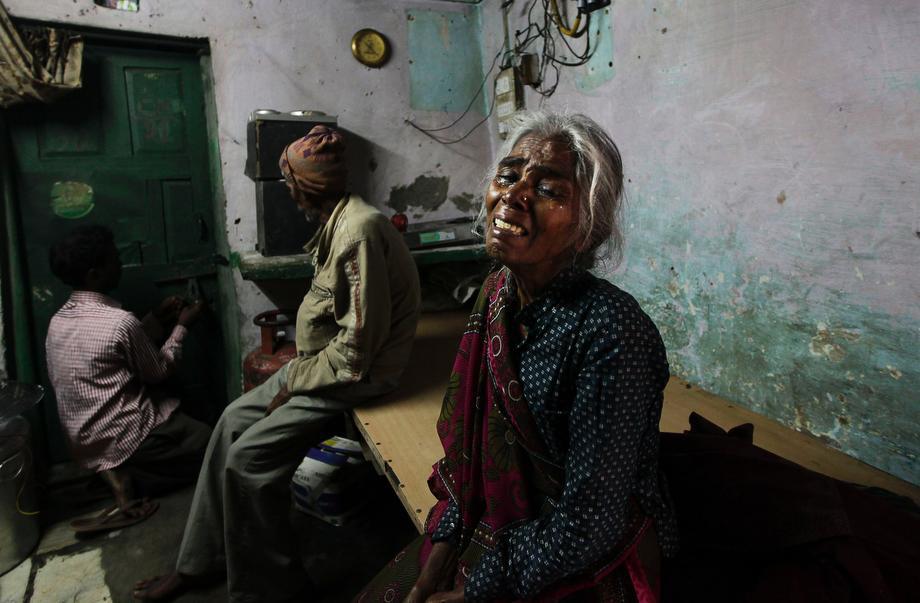 The mother of Ram Singh, the man accused of driving the bus on which a 23-year-old student was gang raped in December 2012, cries as she speaks to journalists inside the family's home in New Delhi, India, on March 11, 2013. Indian police confirmed that Ram Singh, one of the men on trial for his alleged involvement in the gang rape and fatal beating of a woman aboard a New Delhi bus, committed suicide in an Indian jail Monday, but his lawyer and family allege he was killed.